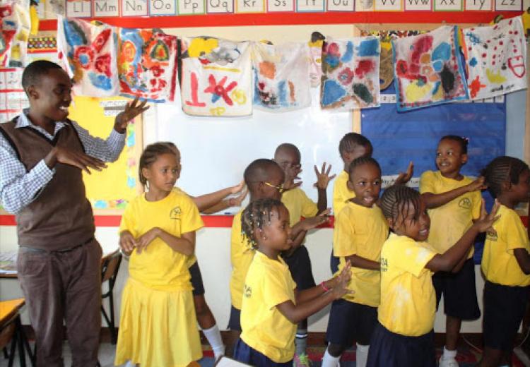 Pupils singing during a class at the Kencada School