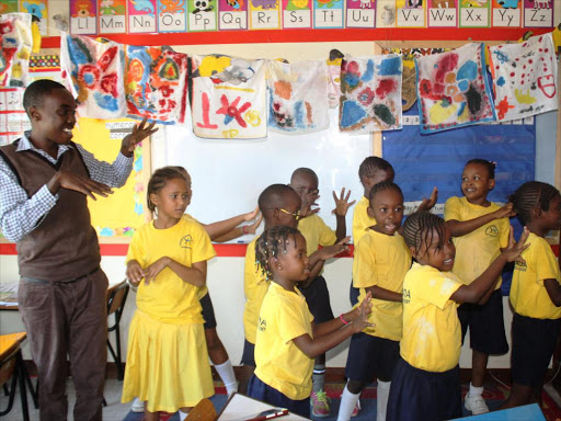 Pupils singing during a class at the Kencada School